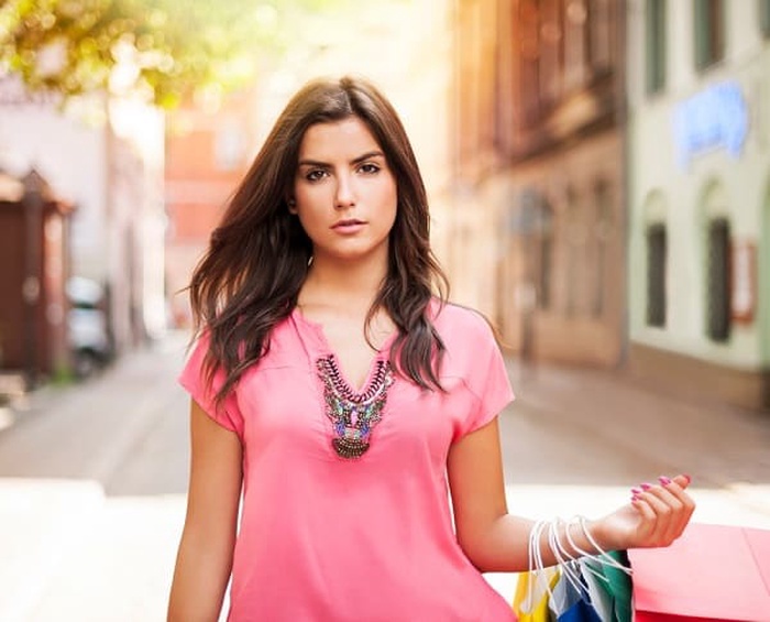 A gorgeous Indian woman with shopping bag on the street