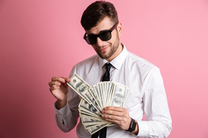 Sugar daddy holding a wad of cash