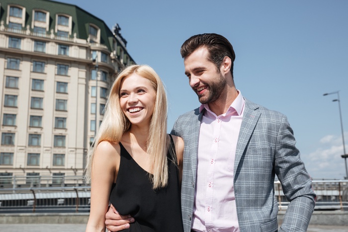 Fashionable sugar baby couple walking in city
