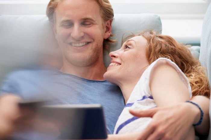Person in first class flight seat enjoying international dating lifestyle