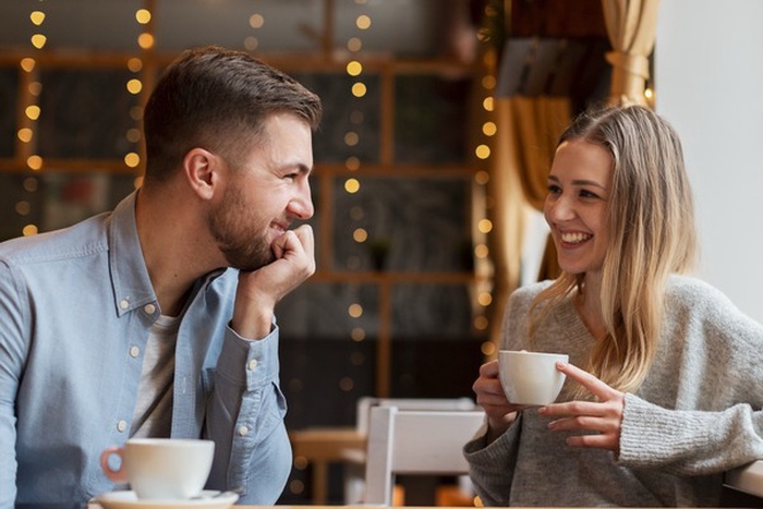 Two adults having a relaxed conversation while using a dating app