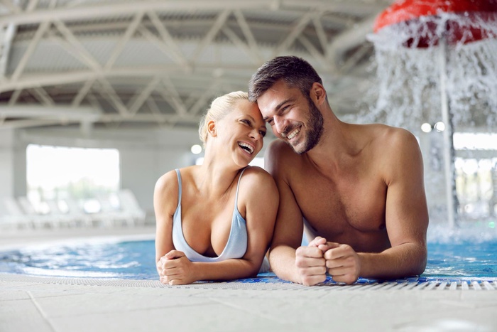 Couple relaxing in thermal pool at spa