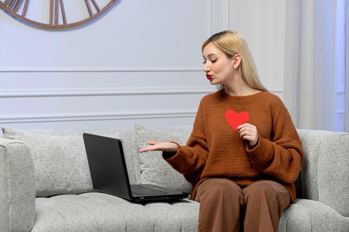 A beautiful woman is sending a wink to her sugar daddy